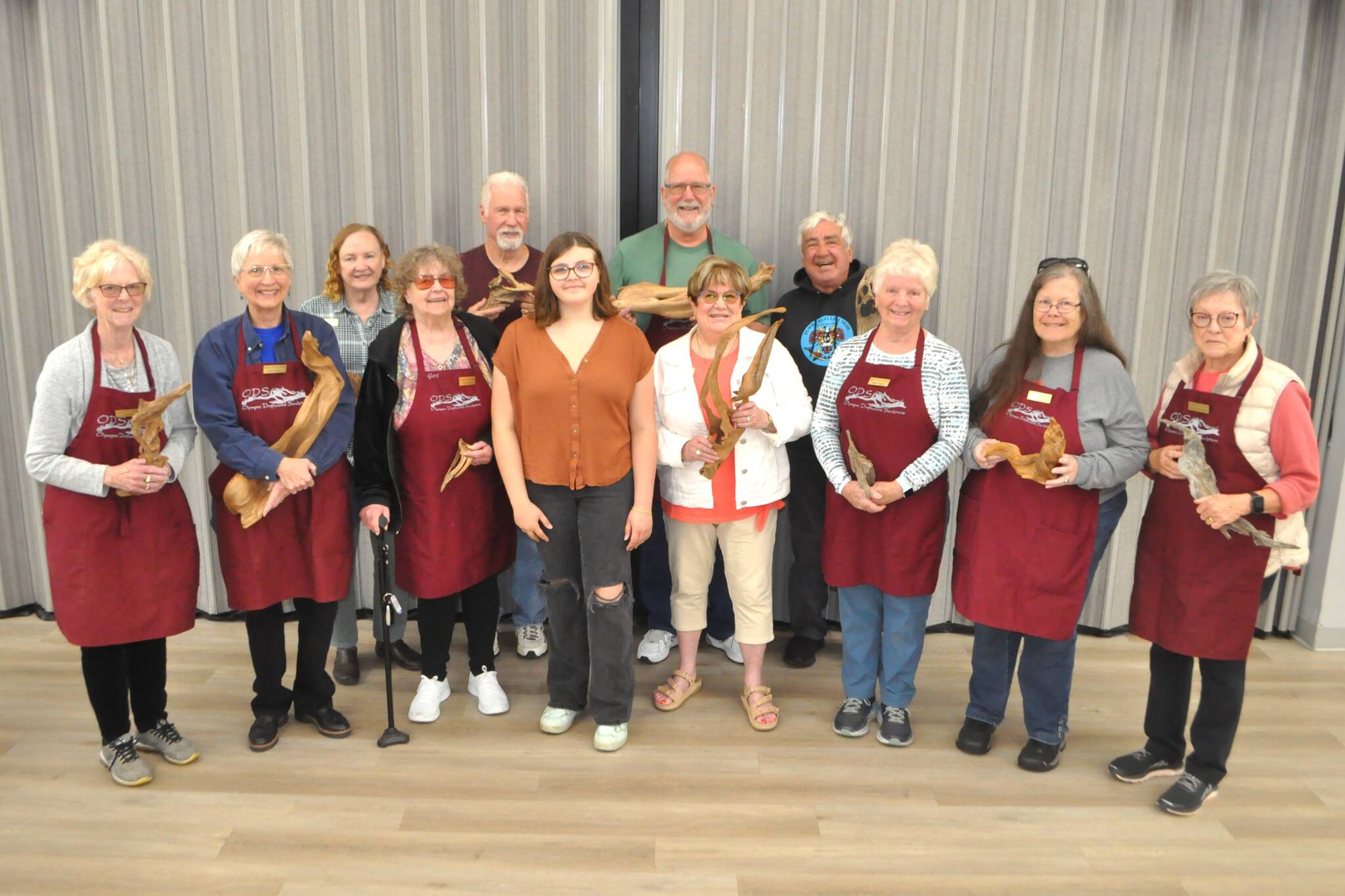 Sequim Gazette photo by Matthew Nash
Some of the Olympic Driftwood Sculptors club members presented Sequim High graduate Kaylie Steed with a $1,500 scholarship July 2 to help her pursuit of a career in art.