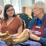 Sequim Gazette photo by Matthew Nash/ Kaylie Steed speaks with Pam Martin, Olympic Driftwood Sculptors scholarship chairperson, during the clubs monthly meeting in July. Steed was chosen by club members to receive a scholarship to start her college studies and become an artist.
