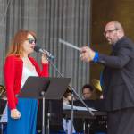 Sequim Gazette photo by Emily Matthiessen/ Sarah Shea sings with the Sequim City Band while Tyler Benedict conducts during the Independence Day celebration at Carrie Blake Community Park.
