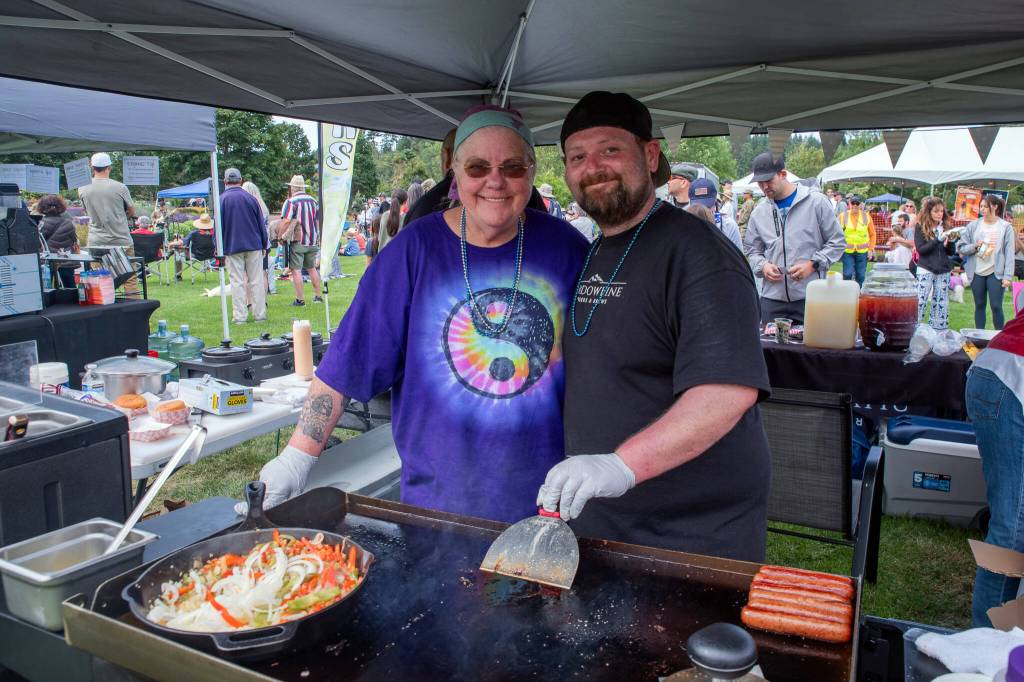 Sequim Gazette photo by Emily Matthiessen/ Angela and Jeffrey Anderson, mother and son duo of Shadowline, served up burgers until fireworks time at Carrie Blake Community Park during Sequims Independence Day celebration.