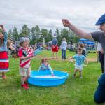 Sequim Gazette photo by Emily Matthiessen/ Shane Leininger plays with his son Ronan, 4, in the hat, alongside, from left to right, Madison Casteel, 7, Olivia Dyer, 4 and Leon Dyer, 2, during Sequim Citys Independence Day celebration at Carrie Blake Community Park.