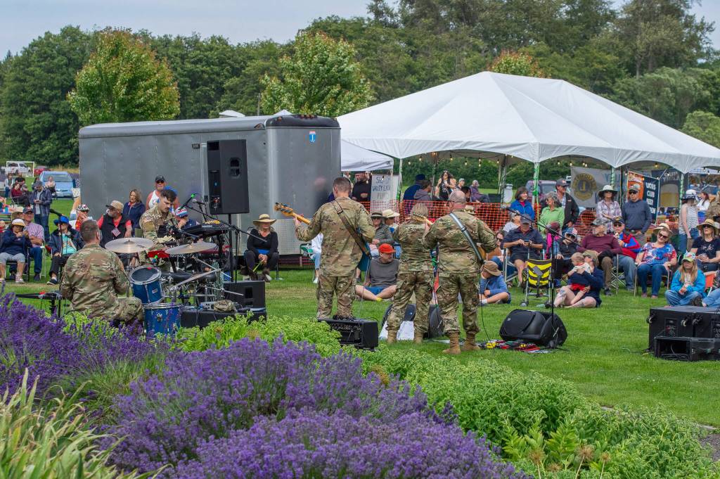 Sequim Gazette photo by Emily Matthiessen/ At Carrie Blakes Botanical Terrace Garden, the 133d Washington Army National Guard Band, from Camp Murray, perform rock and pop music for an appreciative crowd during Sequim Citys Independence Day celebration.