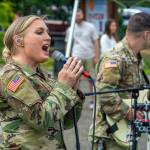 Sequim Gazette photo by Emily Matthiessen/ Tricia Scheer, band leader of the 133d Washington Army National Guard Band from Camp Murray, belts out a rock song on Friday at the City of Sequims Independence Day celebration in Carrie Blake Community Park.