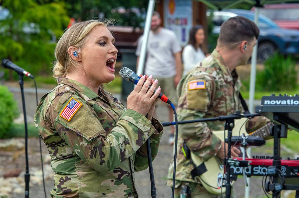 Sequim Gazette photo by Emily Matthiessen/ Tricia Scheer, band leader of the 133d Washington Army National Guard Band from Camp Murray, belts out a rock song on Friday at the City of Sequims Independence Day celebration in Carrie Blake Community Park.