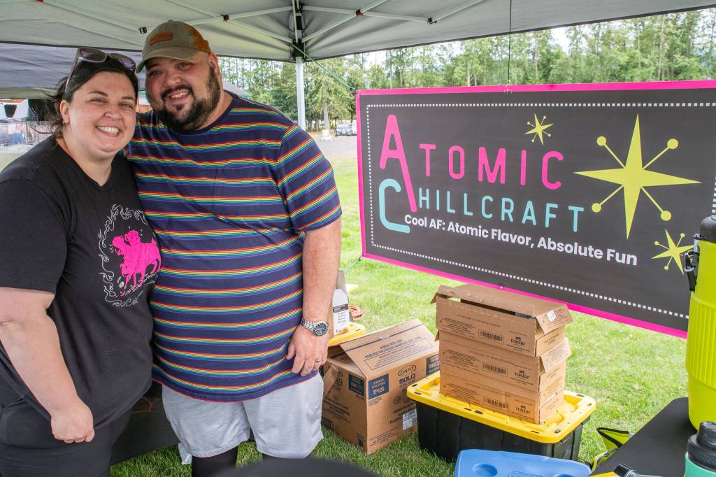 Sequim Gazette photo by Emily Matthiessen/ Wife and husband team Kodi Semon and Mario Arruda debut their icy drink business Atomic Chillcraft at the Independence Day Celebration in Carrie Blake on Friday. Well see where it goes, they say.