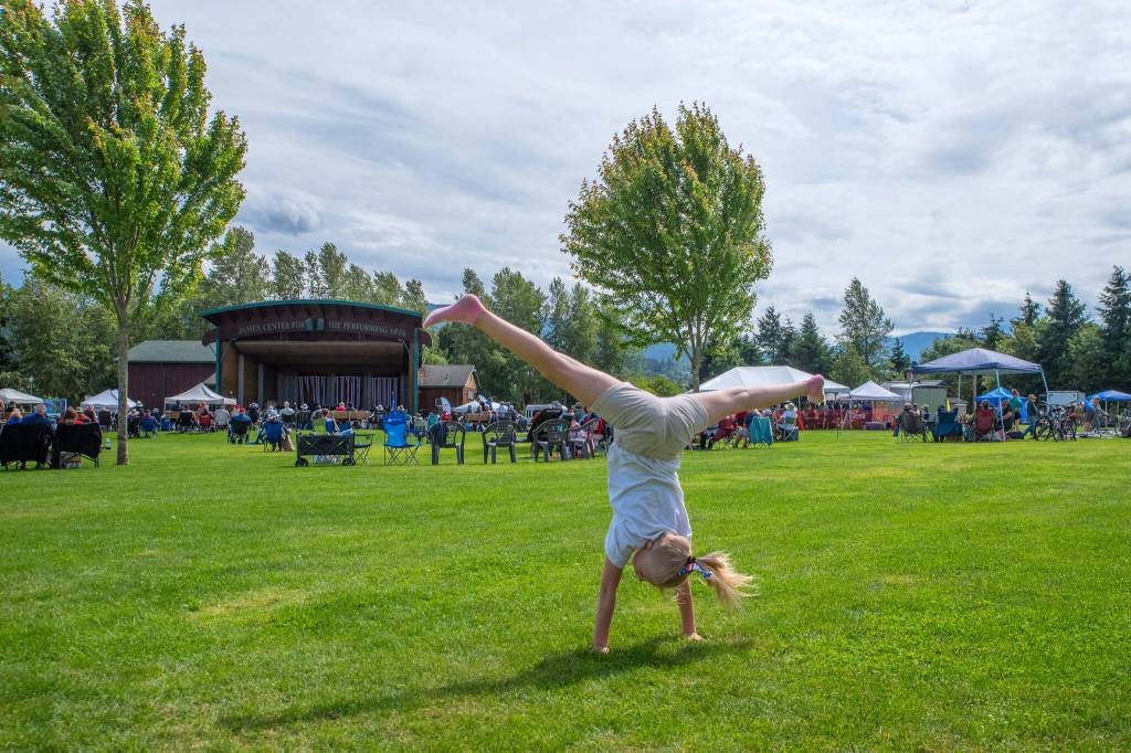 Sequim Gazette photo by Emily Matthiessen/ Maddie Parker, 10, turns cartwheels at Carrie Blake Community Park during the Independence Day celebration on Friday.