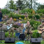 Sequim Gazette photo by Emily Matthiessen/ At Carrie Blakes Botanical Terrace Garden, the 133d Washington Army National Guard Band, from Camp Murray performs rock and pop music for an appreciative crowd during Sequim Citys Independence Day celebration. From left to right: Glenn Devage, Joseph Ballestrasse, Marcus Jaffe, Tricia Scheer and Bradley Patton.