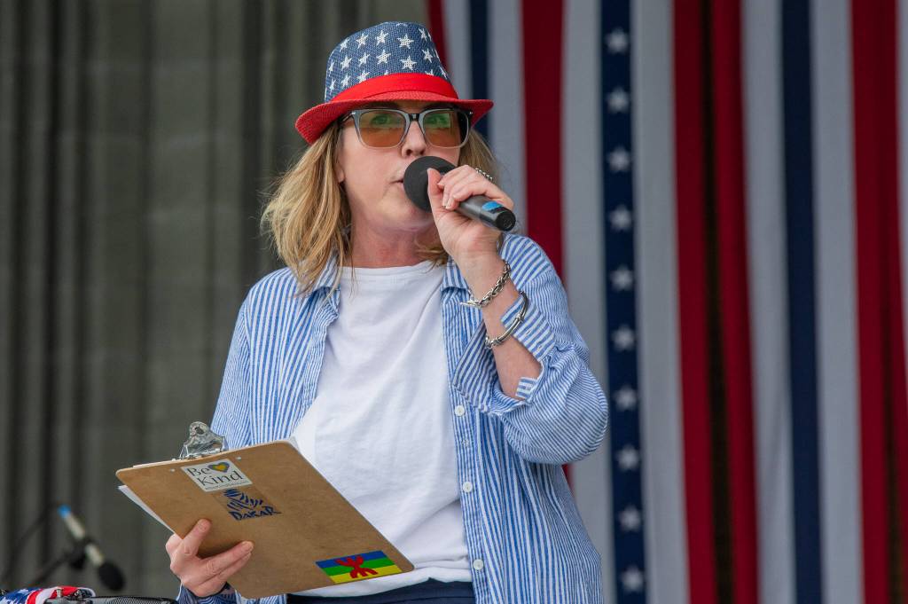 Sequim Gazette photo by Emily Matthiessen/ Brigitte Schlemmer announces during Sequim Citys Independence Day celebration at the James Center Bandshell in Carrie Blake Park Community Park on Friday.