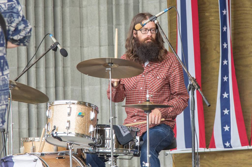 Sequim Gazette photo by Emily Matthiessen/ Dave Bush plays drums for Casey Freedom at the James Center Bandshell during the Independence Day Celebration.