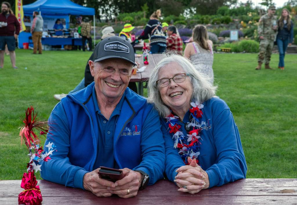 Sequim Gazette photo by Emily Matthiessen/ David and Janet Proebstel share a laugh during Sequims Independence Day celebration at Carrie Blake Park on Friday. The Proebstels are the only remaining charter members of the Sequim City Band, which began in 1992, they said.