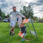 Sequim Gazette photo by Emily Matthiessen/ Watched by father Kelly, Sam Burger plays during Sequim Citys Independence Day celebration at Carrie Blake Community Park.