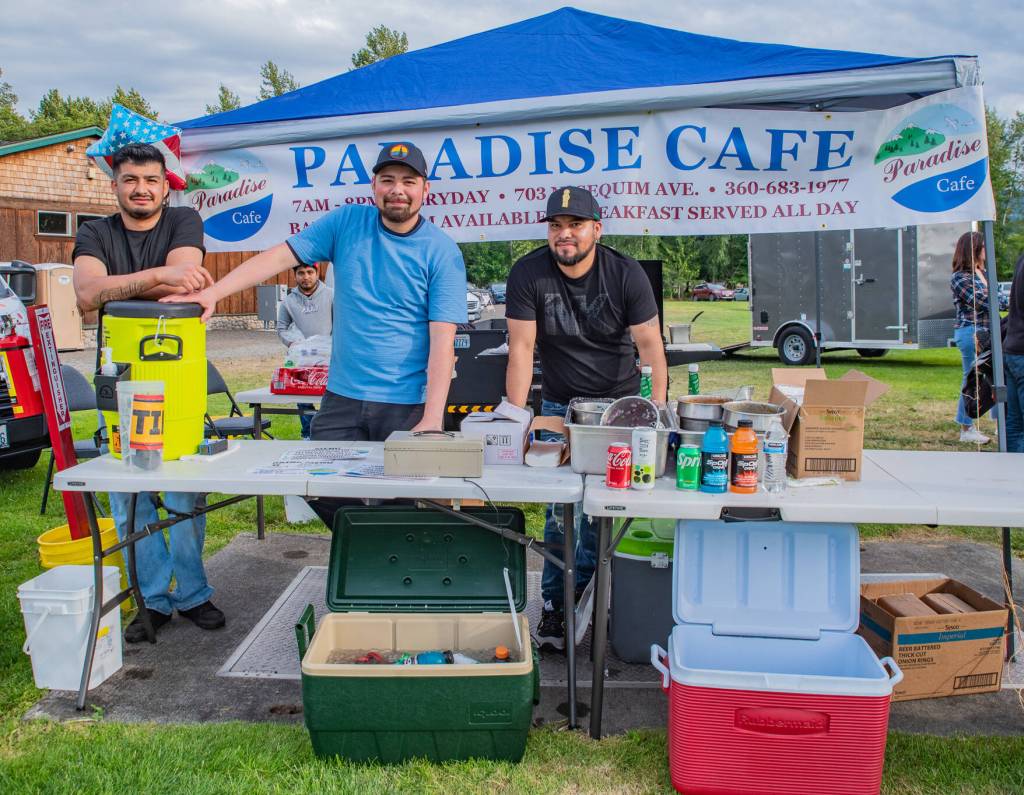 Sequim Gazette photo by Emily Matthiessen/ Refugio Castillo, Josue Gallegos and Francisco Hernandez of the Paradise Cafe serve up delicious tacos during the Independence Day celebration at Carrie Blake Community Park on Friday.