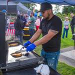 Sequim Gazette photo by Emily Matthiessen/ Francisco Hernandez grills tacos in the Paradise Cafes stall at Carrie Blake Community Parks Independence Day celebration on Friday.