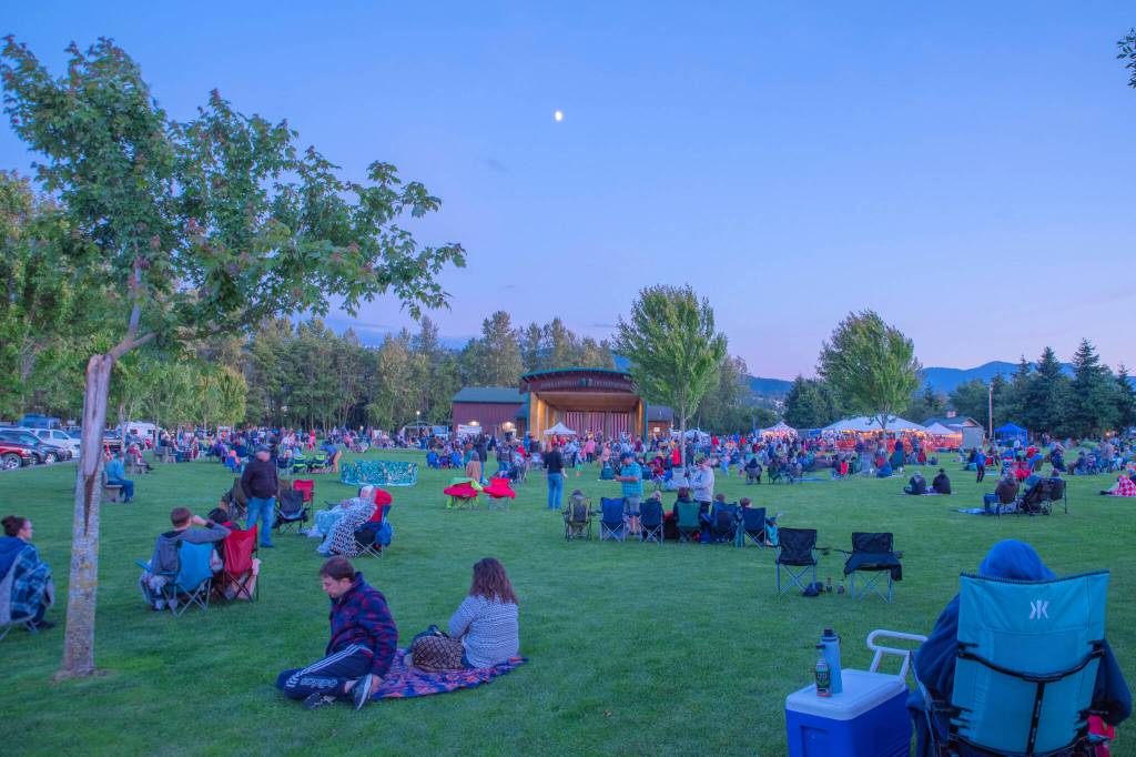 Sequim Gazette photo by Emily Matthiessen/ As Independence Day turns to night at Carrie Blake Community Park, people listen to the music of the band Great American Trainwreck.