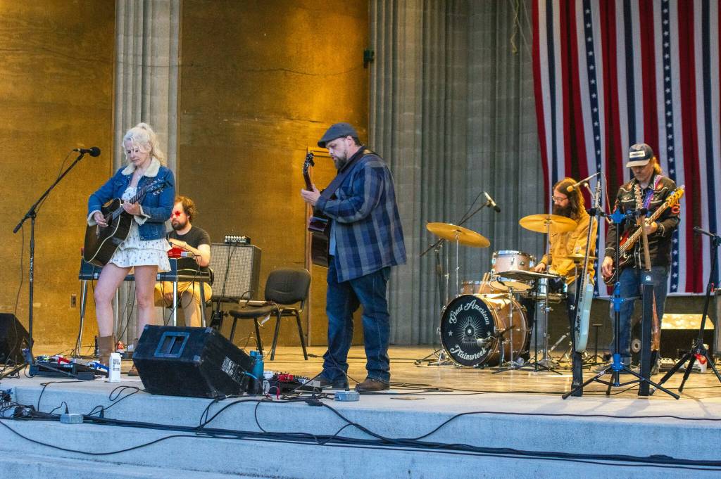 Sequim Gazette photo by Emily Matthiessen/ Great American Trainwrecks Stephanie Ward, David Lux, Nick Nordahl, Dave Bush and Joe Cable entertain the audience at Carrie Blakes James Center Bandshell during the Independence Day celebration.