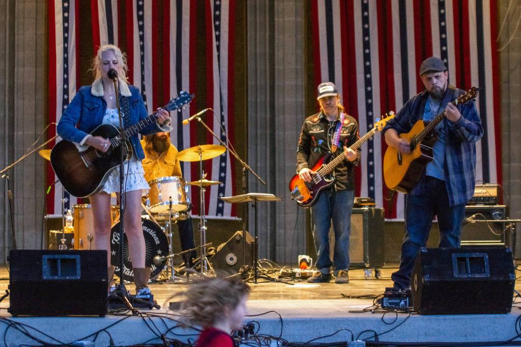 Sequim Gazette photo by Emily Matthiessen/ Great American Trainwrecks Stephanie Ward, Nick Nordahl, Dave Bush and Joe Cable (and David Lux, not seen) entertain the crowd at Carrie Blakes James Center Bandshell during the Independence Day celebration.