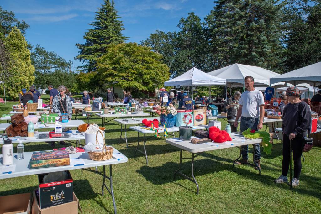 Sequim Gazette photo by Emily Matthiessen/ Silent auction tables at the Sequim Valley Lions Club's 12th Annual Crab Feed offer up a range of items and experiences.