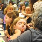 Sequim Gazette photo by Matthew Nash
Volunteer Terra Davis helps Lea Speed, 9, put on her Young Nala the lioness makeup for The Lion King Jr. before a rehearsal at Sequim High Schools Auditorium. The show runs July 18-27 over two weekends.