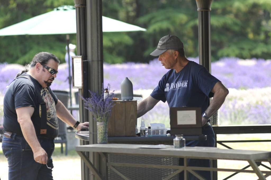 Sequim Gazette photo by Matthew Nash/ Rick Olson discusses essential oils with visitors of Lavender Connection.