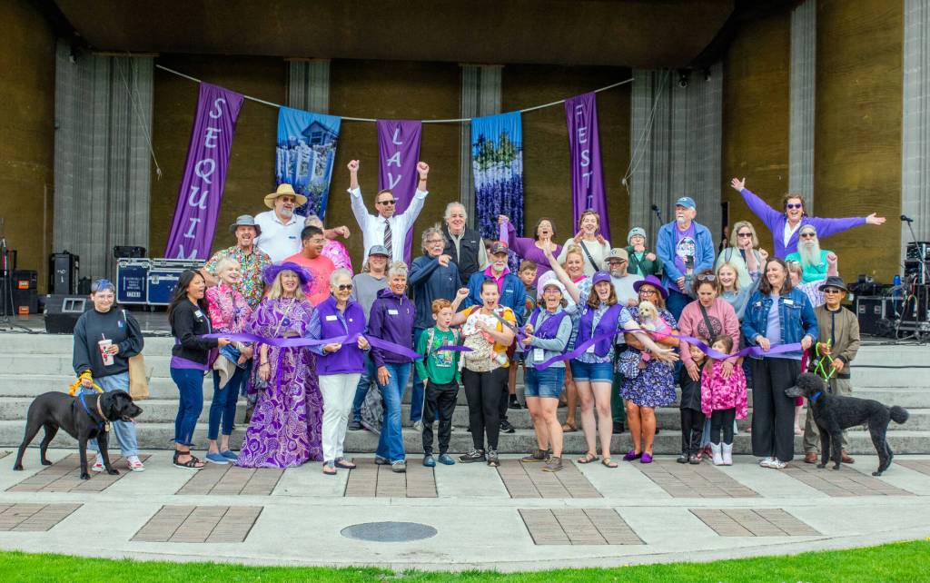 Sequim Gazette photo by Emily Matthiessen/ Local dignitaries and members of the community gather for the ribbon cutting ceremony of the Sequim Lavender Festival on July 18.