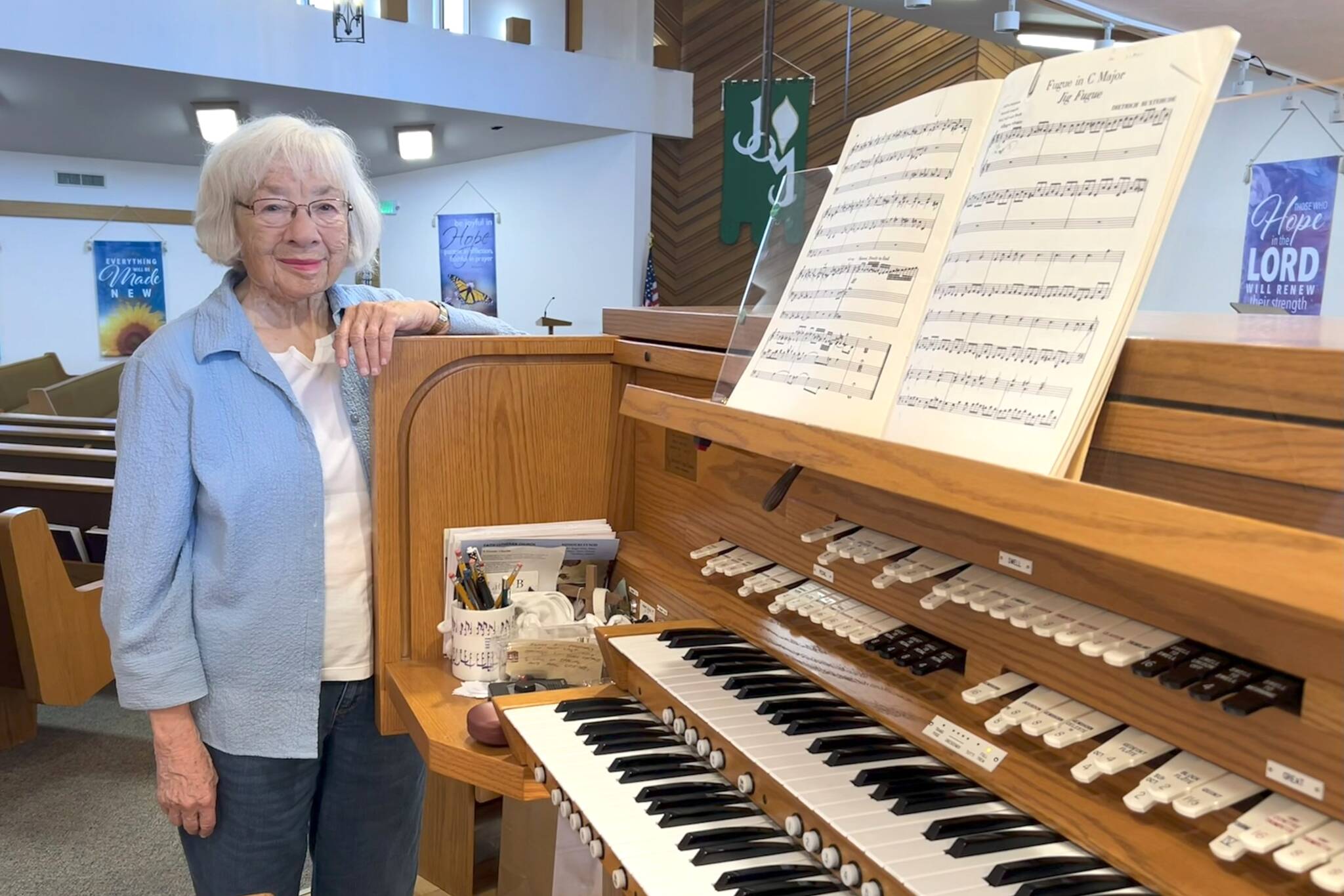 Sequim Gazette photo by Matthew Nash
Pat Marcy stands by the organ in Faith Lutheran Church shes played since it was built in 1991. This summer marks her 50th year leading music at the church, and with her retirement a new director of parish music will start on Aug. 3.