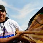 Sequim Gazette photo by Jacques Star/ Chas James of the Swinomish Tribe carries handmade paddles ashore.