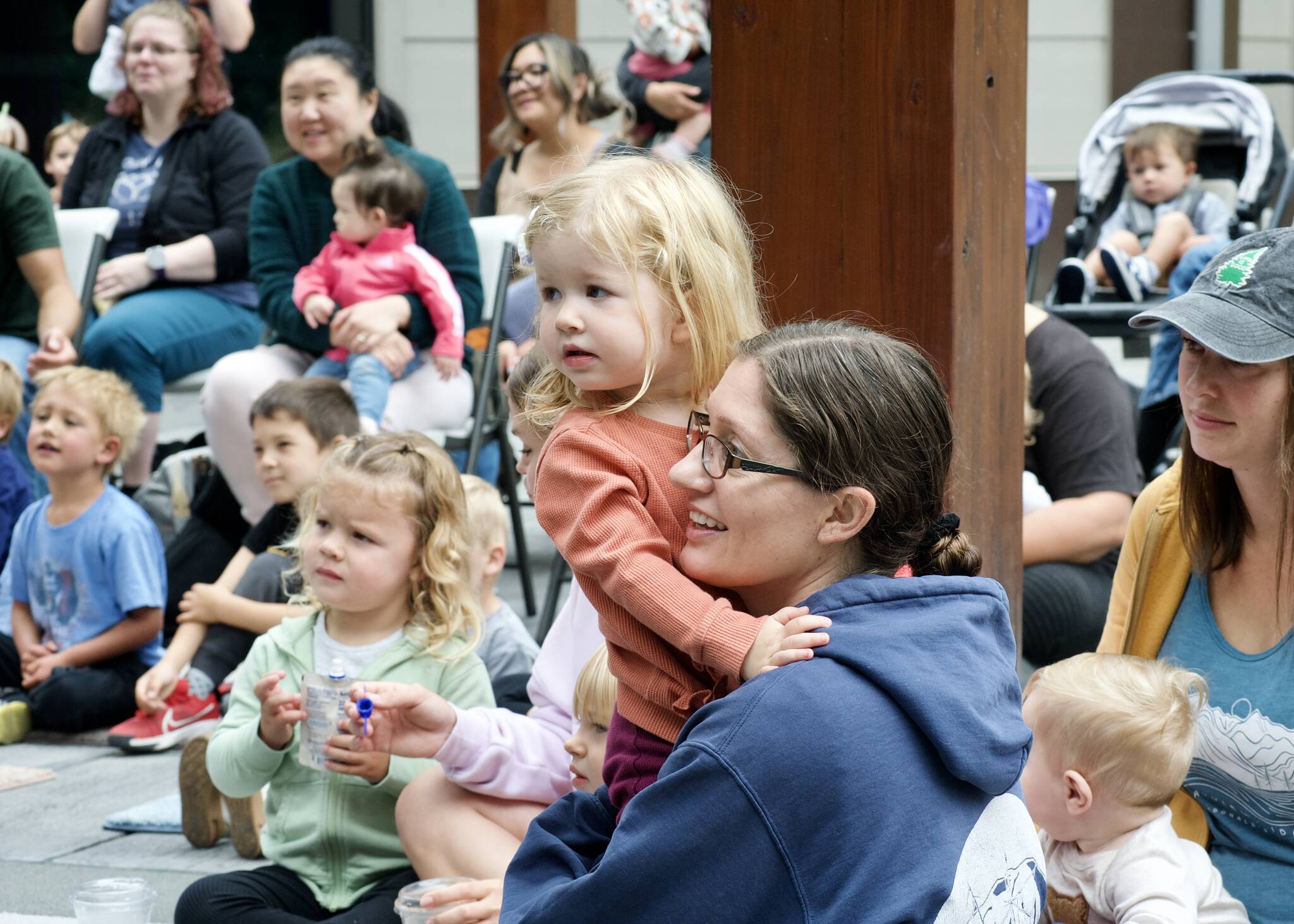 Jessica Bond and her daughter Cora were a rapt audience for Jennifer LuBecke of NOLS as she led an outdoor program for little ones.