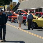 Visitors downtown stroll among the vehicles participating in the annual Sequim Prairie Nights event.