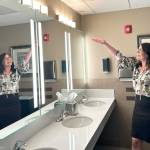 Sequim Gazette photo by Matthew Nash/ Namaste Stayton, vice-president of hotel operations, highlights a remodeled bathroom at the Holiday Inn Express & Suites. Theres new fixtures, lights and countertops in all the bathrooms, she said.