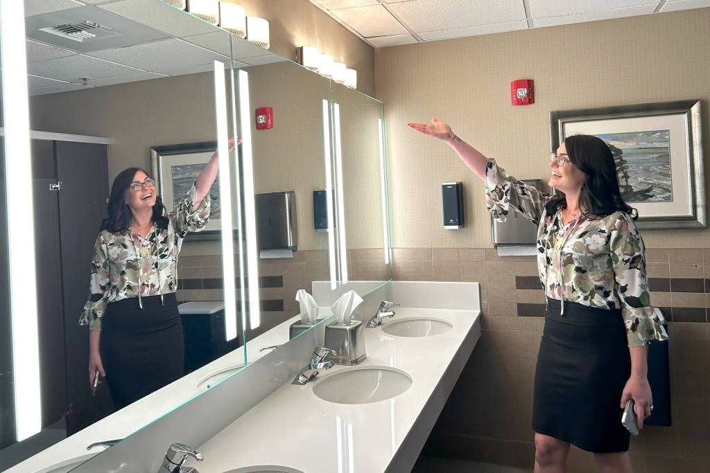 Sequim Gazette photo by Matthew Nash/ Namaste Stayton, vice-president of hotel operations, highlights a remodeled bathroom at the Holiday Inn Express & Suites. Theres new fixtures, lights and countertops in all the bathrooms, she said.