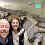 Photo courtesy Wirta Hospitality Worldwide/ Bret Wirta, owner of Holiday Inn Express & Suites, and Namaste Stayton, vice-president of hotel operations, stand by a large pile of carpet that was replaced during a recent remodel.