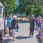 Sequim Gazette photo by Emily Matthiessen
Local resident and tour guide Bob Steelquist provides directions to American Cruise Lines passengers after they arrive by van at the Dungeness River Nature Center in Sequim.