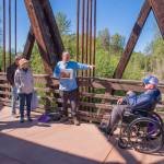 Sequim Gazette photo by Emily Matthiessen
Bob Steelquist, a member of the board of the Dungeness River Nature Center and a tour guide for Olympic Hiking Company, provides details about the Dungeness River to a group of cruise ship passengers while standing on the Dungeness River Railroad Bridge.