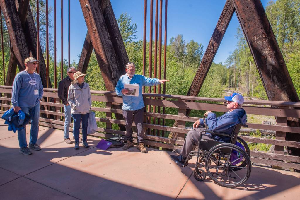 Sequim Gazette photo by Emily Matthiessen
Bob Steelquist, a member of the board of the Dungeness River Nature Center and a tour guide for Olympic Hiking Company, provides details about the Dungeness River to a group of cruise ship passengers while standing on the Dungeness River Railroad Bridge.