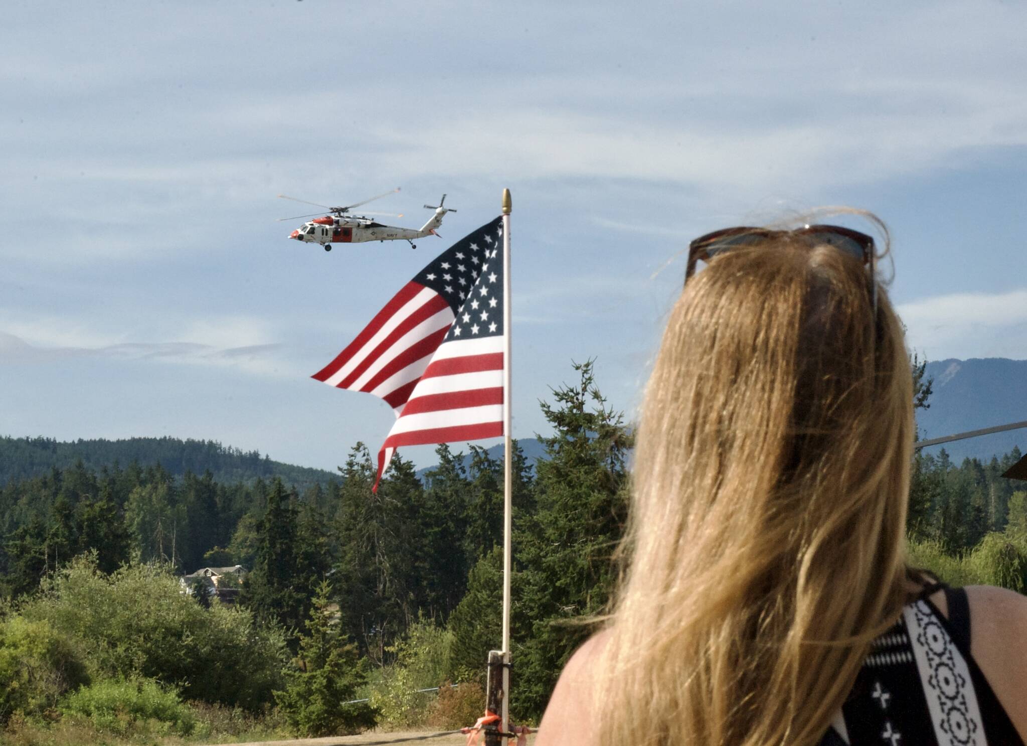 Sequim Gazette photos by Jacques Star 
Michelle Willis watches as a Coast Guard helicopter prepares to land at Saturdays Unity of Effort event in Sequiim.