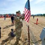 Staff Sgt. Chris Hills with the Washington State National Guard watches with his wife Michelle as a Coast Guard helicopter comes in for a landing at the Aug. 9 Unity of Effort event celebrating and honoring the military and first responders.