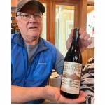 Photo by James Garlick/ Don Corson, co-owner of Camaraderie Cellars, shows off Rondo, a new wine created in partnership with the organizers of Music on the Strait. The bottle's label was created by local designer Tom Eykemans.