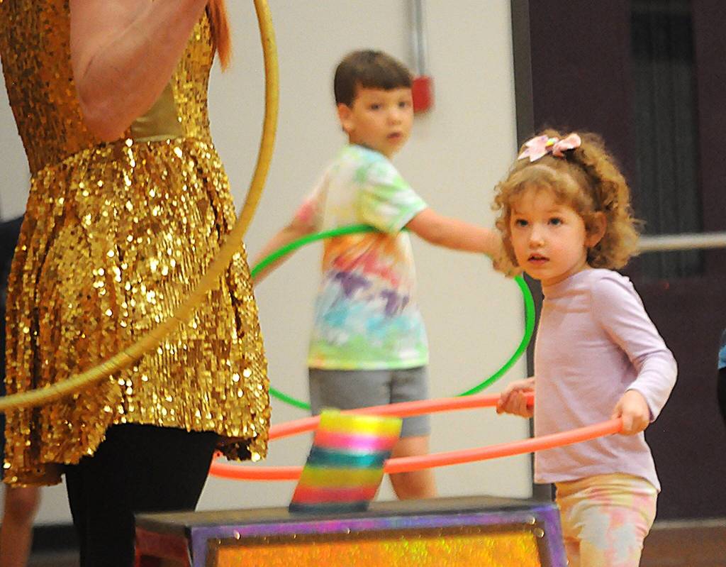 Sequim Gazette photo by Matthew Nash/ Vienna Beck of Port Angeles practices hula hooping with Hillia Hula at the North Olympic Library Systems Summer Reading Program.