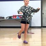 Kirra Thornburg of Port Angeles stands on one foot as she wins the hula hoop contest on Aug. 14 at the Sequim Librarys Summer Reading Program event.