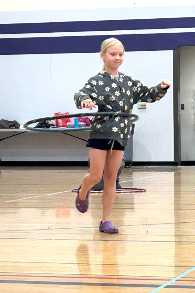 Kirra Thornburg of Port Angeles stands on one foot as she wins the hula hoop contest on Aug. 14 at the Sequim Librarys Summer Reading Program event.
