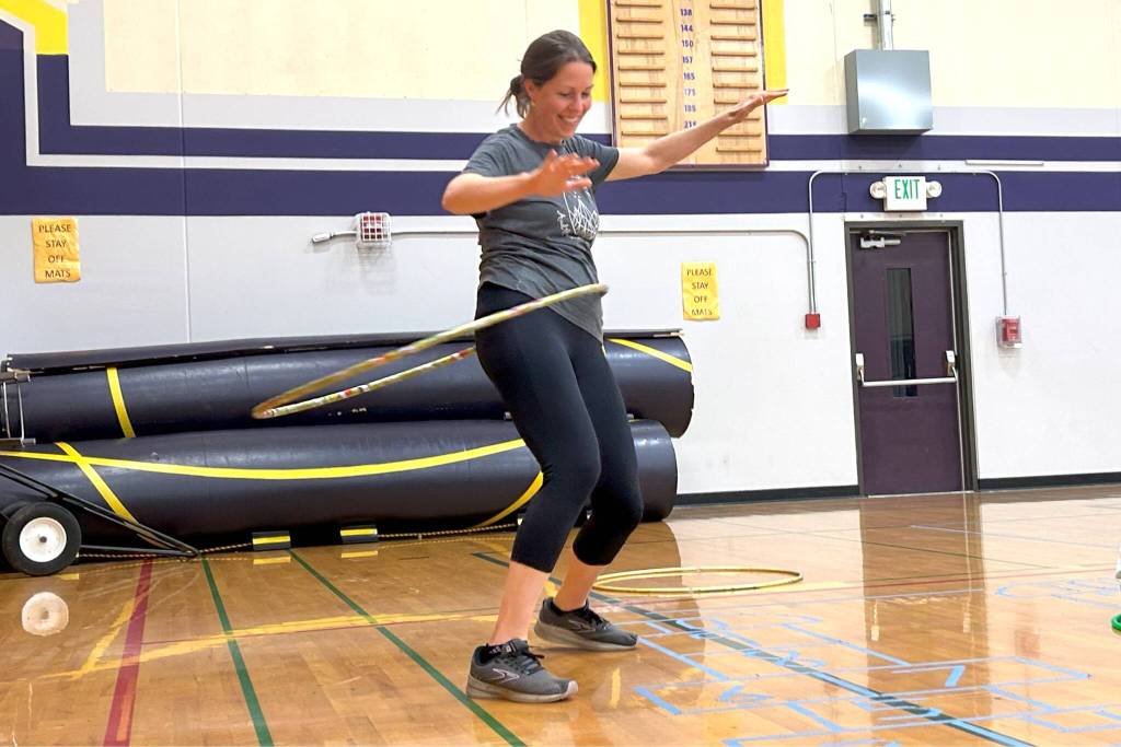 Sequim Gazette photo by Matthew Nash
Above: Michelle Eisen of Everett hula hoops on Aug. 14 at the North Olympic Library Systems hula hoop event in Olympic Peninsula Academys gym. Eisen said she and her three sons were visiting their grandmother in Sequim.