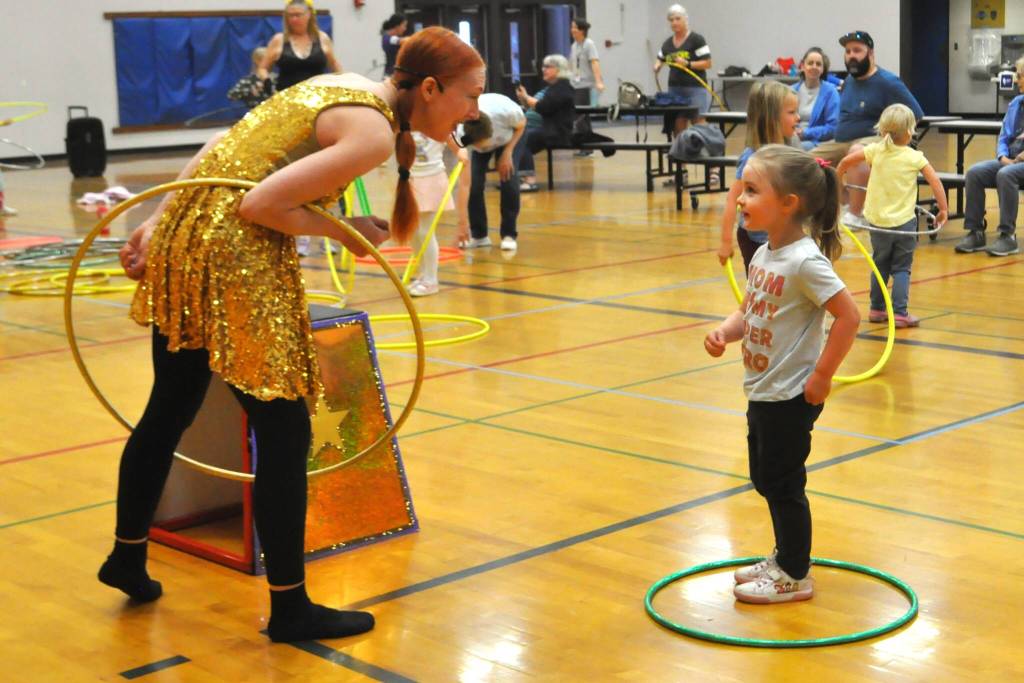 Sequim Gazette photo by Matthew Nash/ Hillia Hula speaks with Reyna Envick of Sequim as she and others practice hula hooping on Aug. 14 in Olympic Peninsula Academys gym.