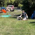 Photo courtesy of Bert Corales and Candace Fagerhaugh/ As Bert Corales looks on, a volunteer from Discovery Bay Wildlife Rescue releases one of the owls back onto the Sequim property where it was born. While in the custody of the rescue organization, the owlet was cared for by a surrogate owl parent.