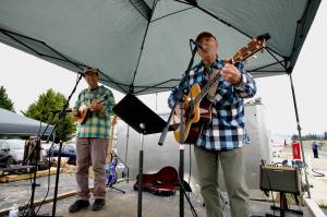 Photos by Jacques Star
The Free Rangers perform some folk originals at the Olympic Peninsula Air Affaire, with Kevin Lee Magner on guitar and Steve Lopes on mandolin and electric bass.