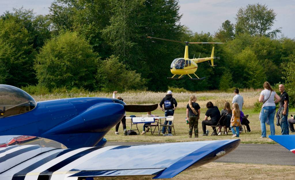 Attendees of the Saturday, Aug. 30 Olympic Peninsula Air Affaire event wait in line for a helicopter ride courtesy of Classic Helicopter Corp. from Seattle.