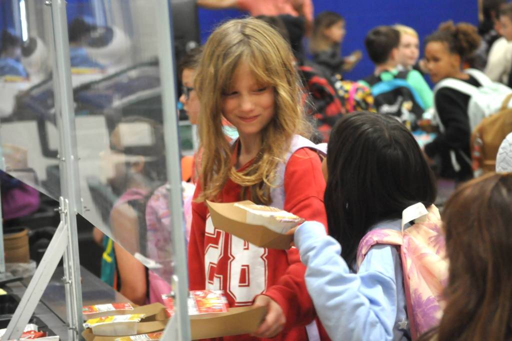 Sequim Gazette photo by Matthew Nash
Willow Christenson, a fourth grader at Helen Haller Elementary, grabs a bite to eat before the first day of school on Aug. 27 at Helen Haller Elementary.