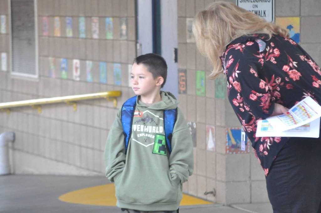 Sequim Gazette photo by Matthew Nash/ Music teacher Laura Lorentzen helps student Caden Reyes find his way before the first day of school at Helen Haller Elementary.