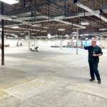 Sequim Gazette photo by Matthew Nash 
Michael Smith, Shipley Centers executive director, points to future amenities in its new space at 651 W. Washington St. Hes standing atop future multi-use courts that can host indoor pickleball, basketball, volleyball and ping pong.