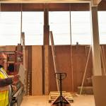 Sequim Gazette photo by Matthew Nash/ NOLS Executive director Noah Glaude stands by the Sequim Librarys east wall where staff and contractors await anchors to finalize installation of windows.