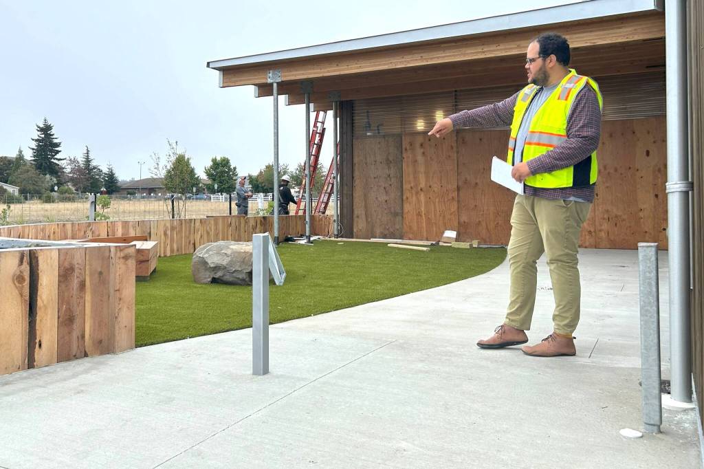 Sequim Gazette photo by Matthew Nash/ The outdoor childrens area of the Sequim Library features benches, a rock, and bouncy turf along with a soon-to-be installed gate and a door directly into the inside childrens area.